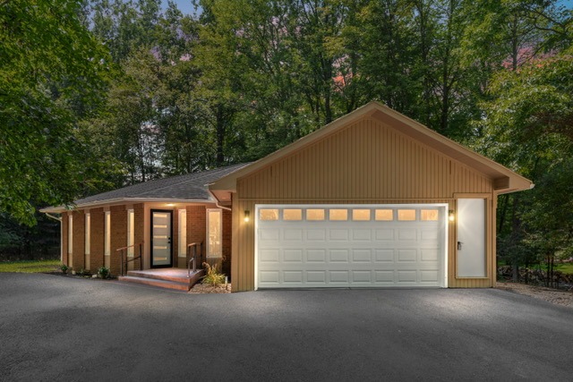 A small house with a parking area in a night view