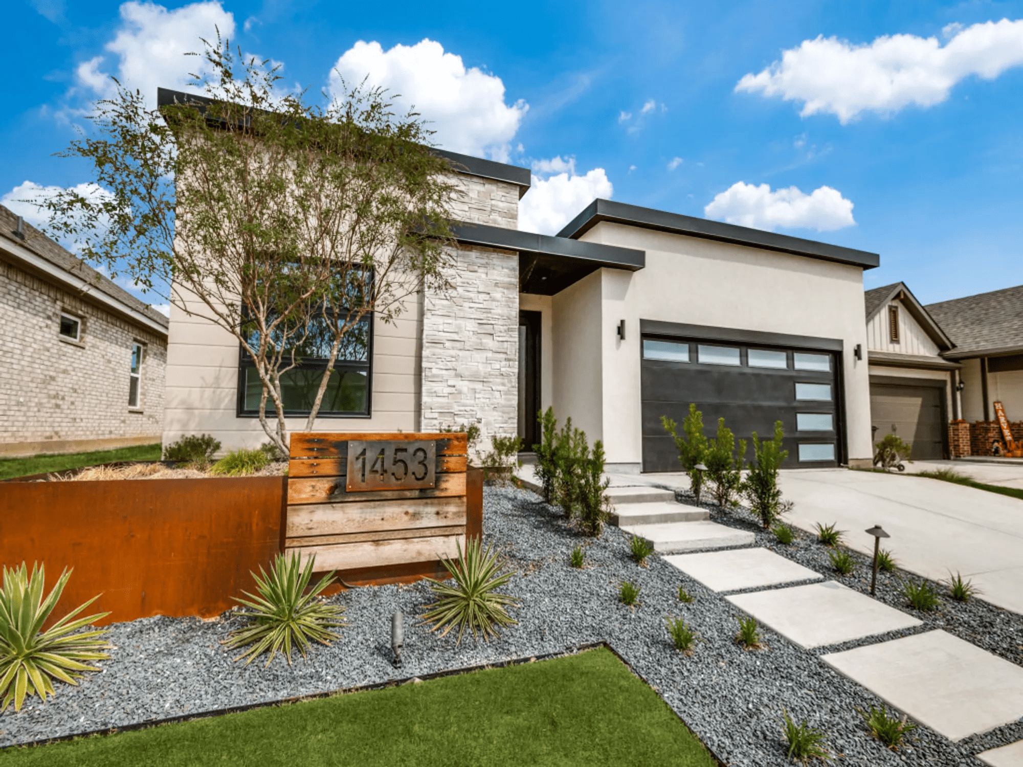 Side view of the exterior of the house with a nice path way and drive way
