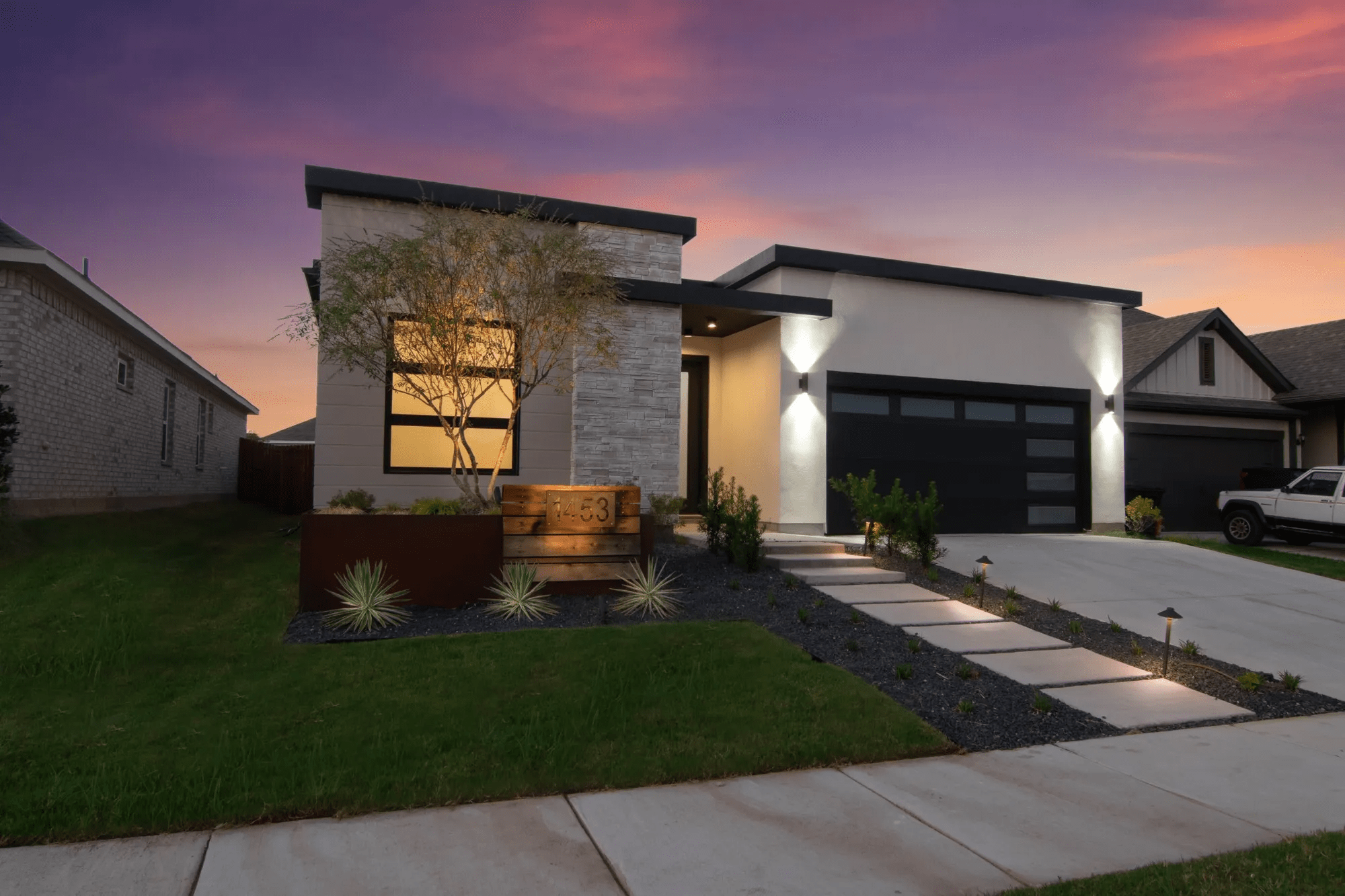 Wider view of newly renovated exterior house with pathway